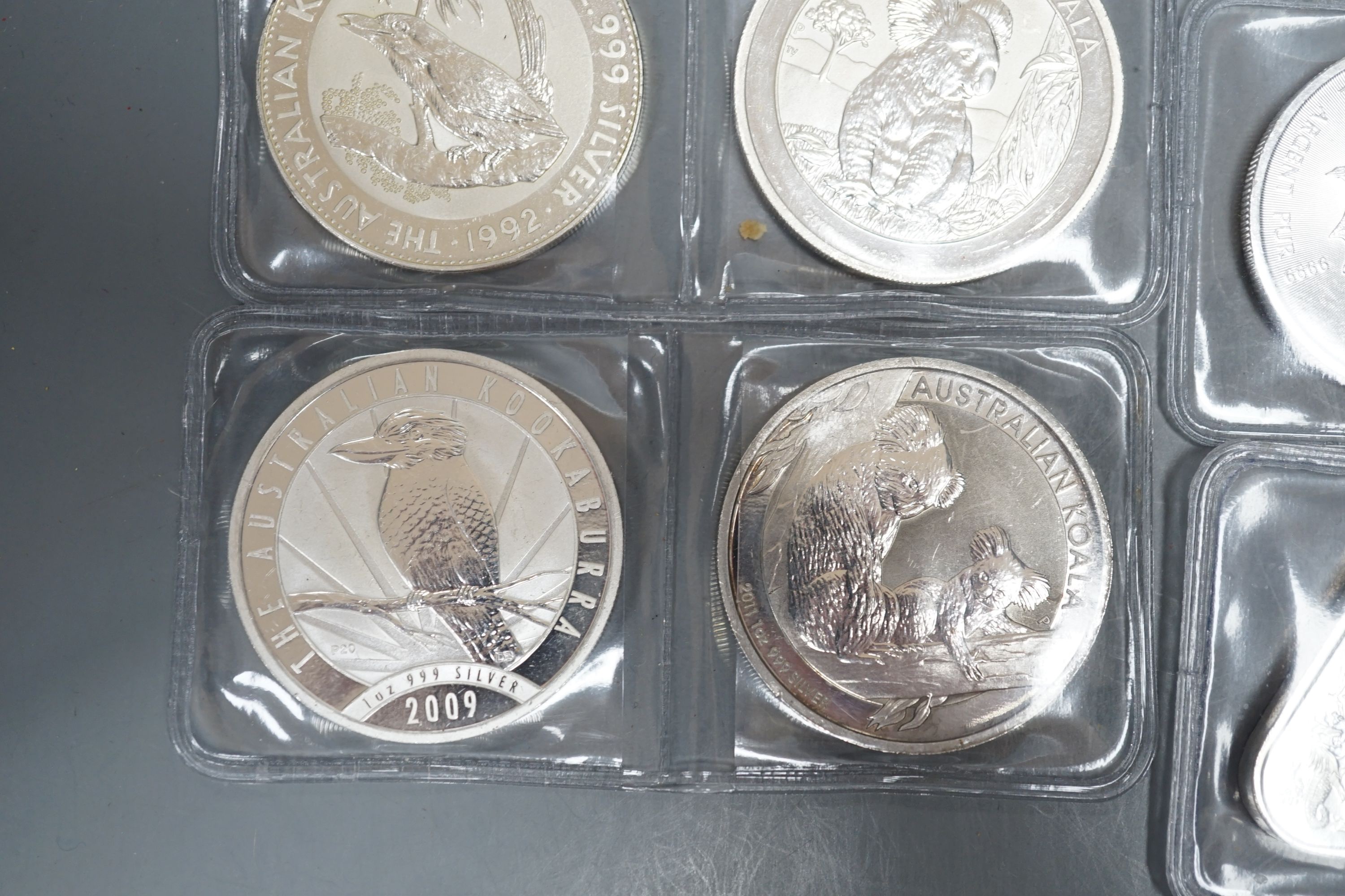 Eight 1oz assorted Australian 1 dollar coins, finesse .999, four 1oz assorted Canadian dollar coins, two silver 1oz coins- Britannia 2019 and George & Dragon, 2021 and two silver Australian triangular 1oz coins, 2019/202